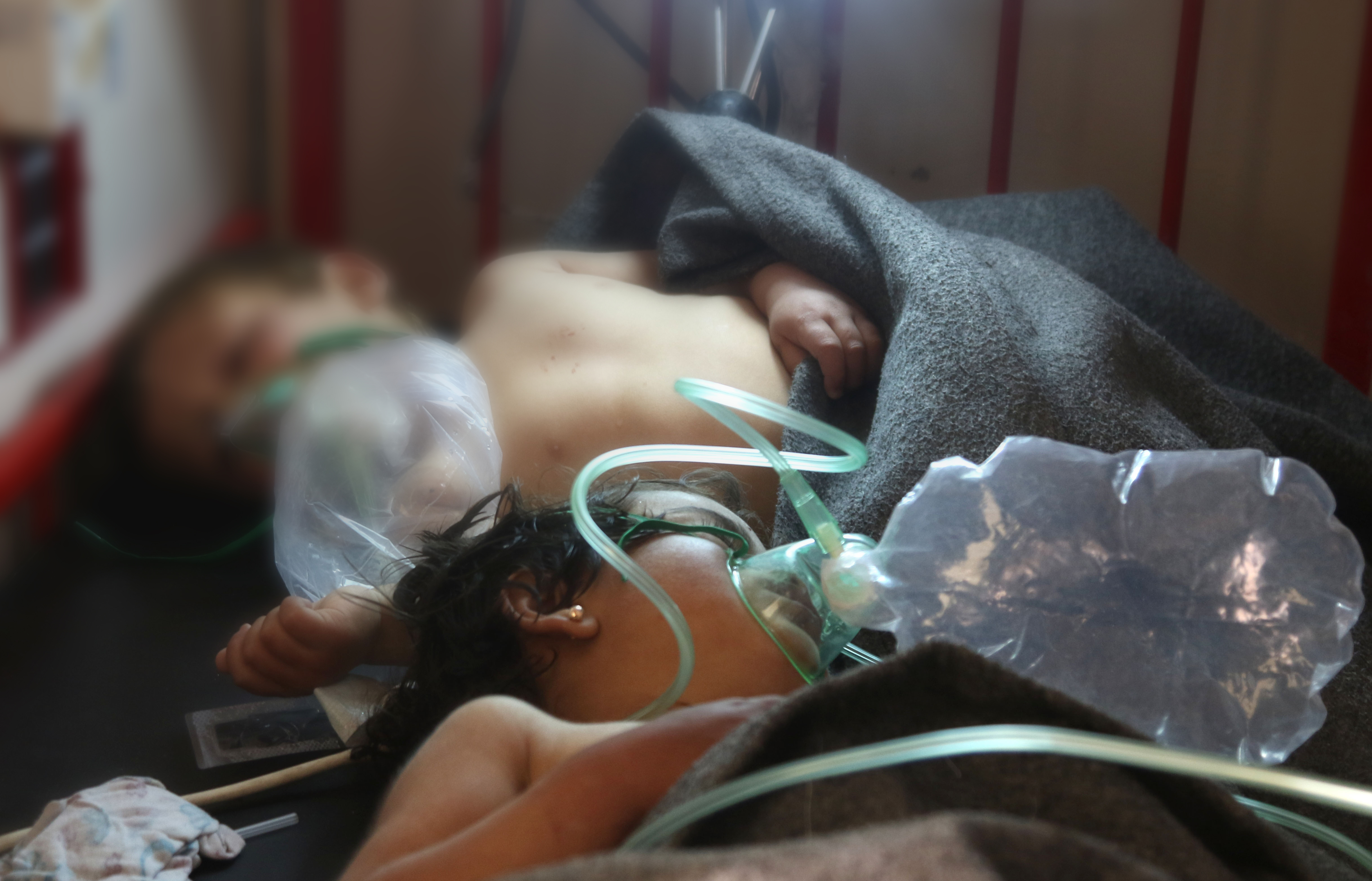 Syrian children receive treatment at a small hospital in the town of Maaret al-Noman following a suspected toxic gas attack in Khan Sheikhun, a nearby rebel-held town in Syrias northwestern Idlib province, on April 4, 2017. Warplanes carried out a suspected toxic gas attack that killed at least 35 people including several children, a monitoring group said. The Syrian Observatory for Human Rights said those killed in the town of Khan Sheikhun, in Idlib province, had died from the effects of the gas, adding that dozens more suffered respiratory problems and other symptoms. / AFP PHOTO / Mohamed al-Bakour / ADDING INFORMATION IN CAPTION (Photo credit should read MOHAMED AL-BAKOUR/AFP/Getty Images)