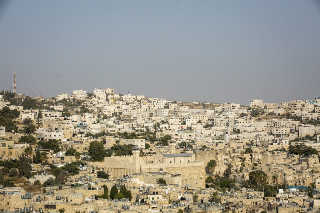 View of Hebron from The Centre for Youth Against Settlements in Hebron, 13 September, 2017. The center is based in an old Palestinian house that used to be an Israeli military base, once the soldiers left the settlers tried to take it, occupying it several times. The YAS group decided to fight and resist the occupation, and after several direct actions and legal challenges the Israeli court finally recognised the building as a legitimate Palestinian property. Issa Amro and Farid al-Atrash want an end to Israeli settlements – a war crime stemming from Israel’s 50-year occupation of Palestinian land. Israel has made many parts of the occupied territories no-go zones for Palestinians, making it impossible for them to move about freely. By contrast, Jewish Israeli settlers are free to go where they wish.  Dedicated to non-violence, Issa and Farid brave constant threats and attacks by Israeli soldiers and settlers. Issa encourages Palestinian youths to find non-violent ways to oppose Israel’s occupation and discriminatory laws in Hebron. For this, Israeli forces have arrested him more than once. They have beaten, blindfolded, and interrogated him. “The Israeli occupation forces target us to silence us,” says Issa. Farid, a lawyer who exposes abuses by the Palestinian and Israeli authorities, faces similar harassment.  In February 2016, Issa and Farid joined a peaceful protest in the city of Hebron marking 22 years since Israel first closed one of its streets, al-Shuhada, to Palestinians. Hebron’s 200,000 Palestinians are effectively held hostage by the 800 Israeli settlers who live in its centre. The men now face ludicrous charges clearly designed to obstruct their human rights work.