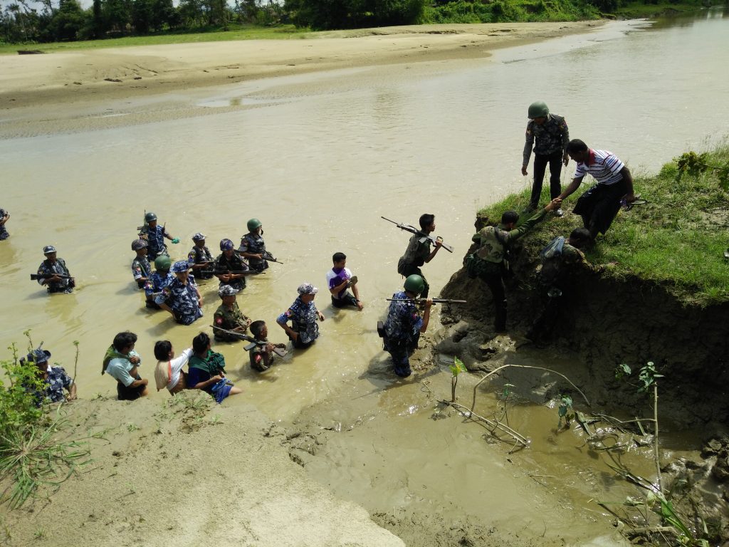 Myanmar security forces accompany Hindu villagers to the site of mass graves where their relatives were buried. The bodies of 45 people from Ah Nauk Kha Maung Seik (in Maungdaw Township, Rakhine State) were unearthed in four mass graves in late September 2017. The victims were among 99 people killed in two massacres perpetrated by Arakan Rohingya Salvation Army (ARSA) fighters on 25 August 2017.