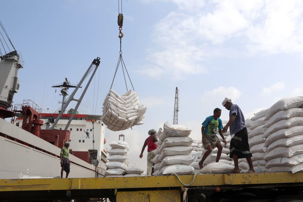 Workers unload wheat assistance provided by UNICEF from a cargo ship at the Red Sea port of Hodeida on January 27, 2018. Hodeida is a key entry point for United Nations aid to war-torn Yemen. / AFP PHOTO / ABDO HYDER        (Photo credit should read ABDO HYDER/AFP/Getty Images)