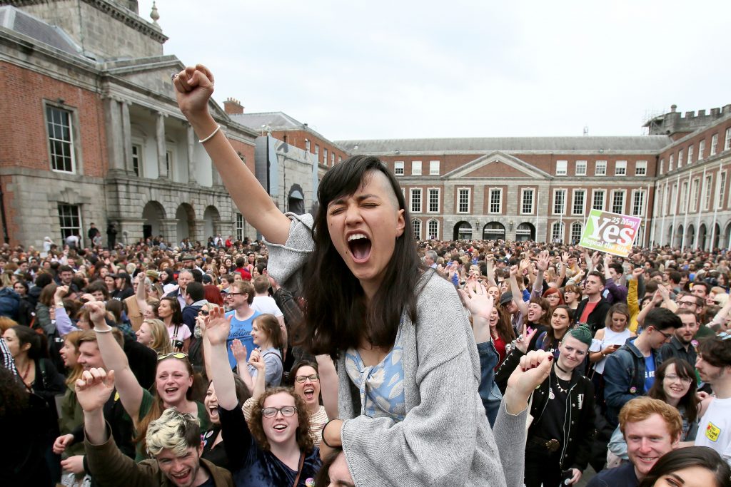 TOPSHOT - 'Yes' campaigners celebrate the official result of the Irish abortion referendum at Dublin Castle in Dublin on May 26, 2018 which showed a landslide decision in favour of repealing the constitutional ban on abortions. - Ireland voted by a landslide to ditch its strict abortion laws in a landmark referendum hailed by Prime Minister Leo Varadkar on Saturday as a "quiet revolution", triggering scenes of jubilation in Dublin. Final results showed 66 percent of voters in what has been a traditionally staunchly Catholic country backed repealing the constitutional ban on terminations. (Photo by Paul FAITH / AFP) (Photo credit should read PAUL FAITH/AFP/Getty Images)