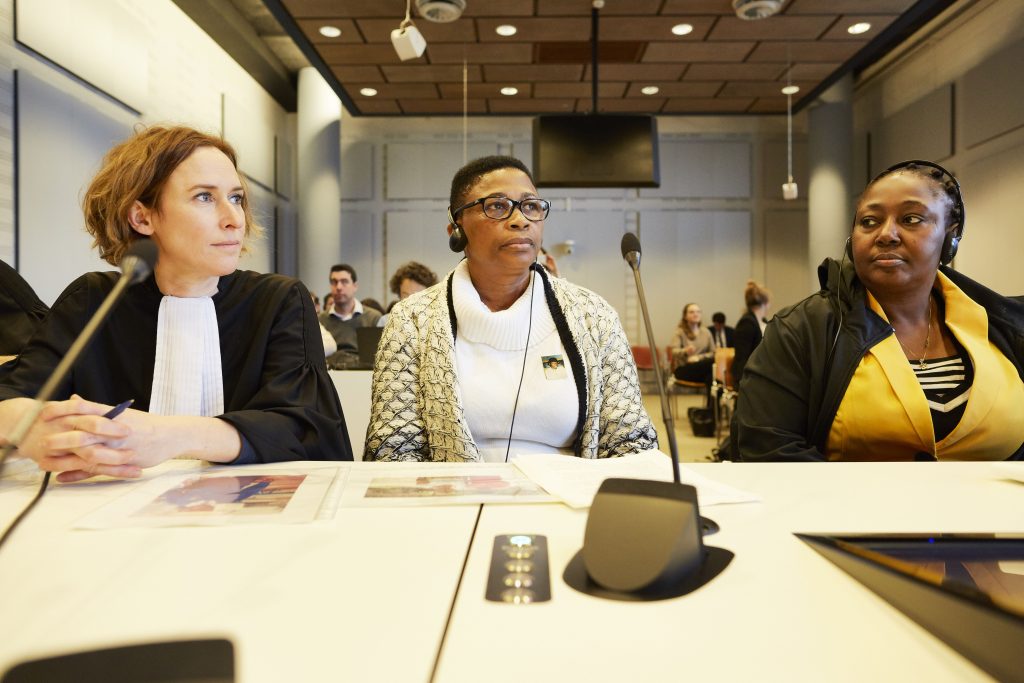 THE HAGUE, NETHERLANDS - FEBRUARY 12: Victoria Bera (R), Esther Kiobel (C) and plaintiff's lawyer Channa Samkalden (L) sit in the court room as a Dutch court hear the first arguments in an historic case against Shell, in which the oil giant stands accused of instigating a raft of horrifying human rights violations committed by the Nigerian government against the Ogoni people in the 1990s, on February 12, 2019 in The Hague, Netherlands. Esther Kiobel, Victoria Bera, Blessing Eawo and Charity Levula are suing Shell over what they say is its role in the unlawful arrest, detention and execution of their husbands by the Nigerian military, following a brutal crackdown on Ogoni protests against Shell’s devastating pollution of the region. (Photo by Pierre Crom/Getty Images)