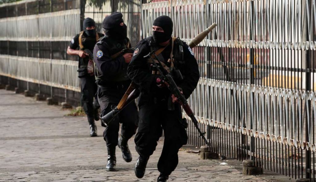 Members of the National Police armed with AK riffles and a RPG-7 type portable grenade launcher in Masaya