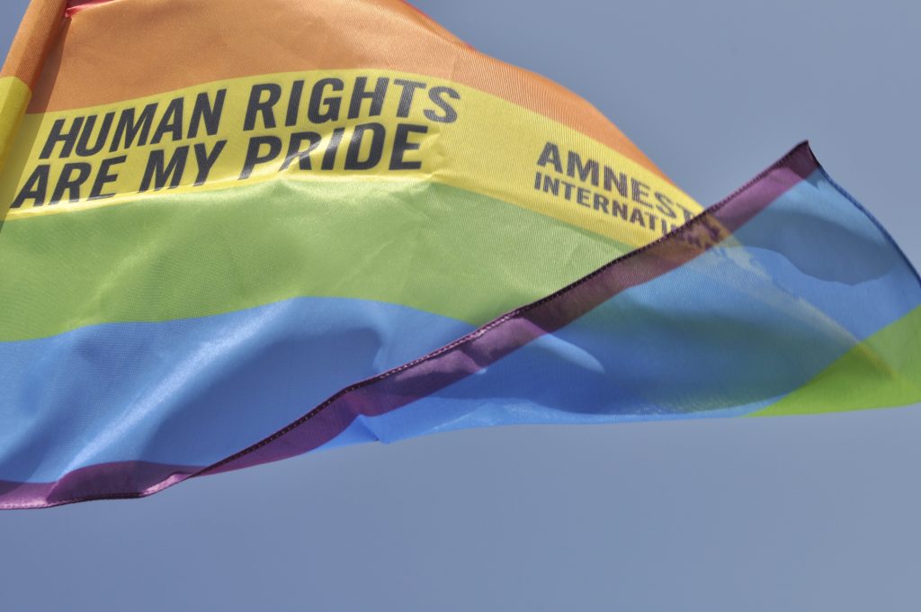 Rainbow flag in Palermo Pride, 22th June 2013. Gay pride flag waving in the breeze with the words, Amnesty International - Human Rights are my Pride.