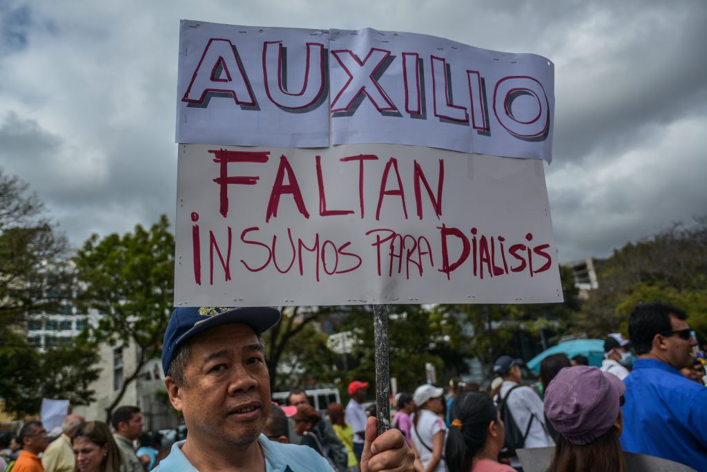 One demonstrator at the protest “We don’t want to die” in Caracas, Venezuela carries a board denouncing the lack supplies and treatments for dialysis in Venezuela