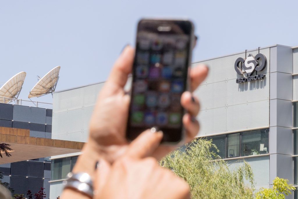An Israeli woman uses her iPhone in front of the building housing the Israeli NSO group, on August 28, 2016, in Herzliya, near Tel Aviv. Apple iPhone owners, earlier in the week, were urged to install a quickly released security update after a sophisticated attack on an Emirati dissident exposed vulnerabilities targeted by cyber arms dealers. Lookout and Citizen Lab worked with Apple on an iOS patch to defend against what was called "Trident" because of its triad of attack methods, the researchers said in a joint blog post. Trident is used in spyware referred to as Pegasus, which a Citizen Lab investigation showed was made by an Israel-based organization called NSO Group. / AFP / JACK GUEZ (Photo credit should read JACK GUEZ/AFP/Getty Images)