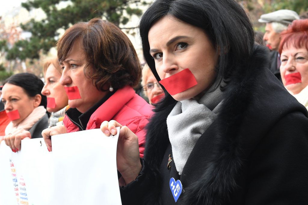 Members from left-wing parties and civil organizations and their sympathizers march with a banner reading 'STOP' as they take part in a flashmob against the Hungarian government's women's policy and against violence against women, on November 23, 2018 in Budapest. (Photo by ATTILA KISBENEDEK / AFP) (Photo credit should read ATTILA KISBENEDEK/AFP/Getty Images)