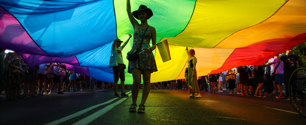 Members of Polish LGBTQ community are seen walking under a