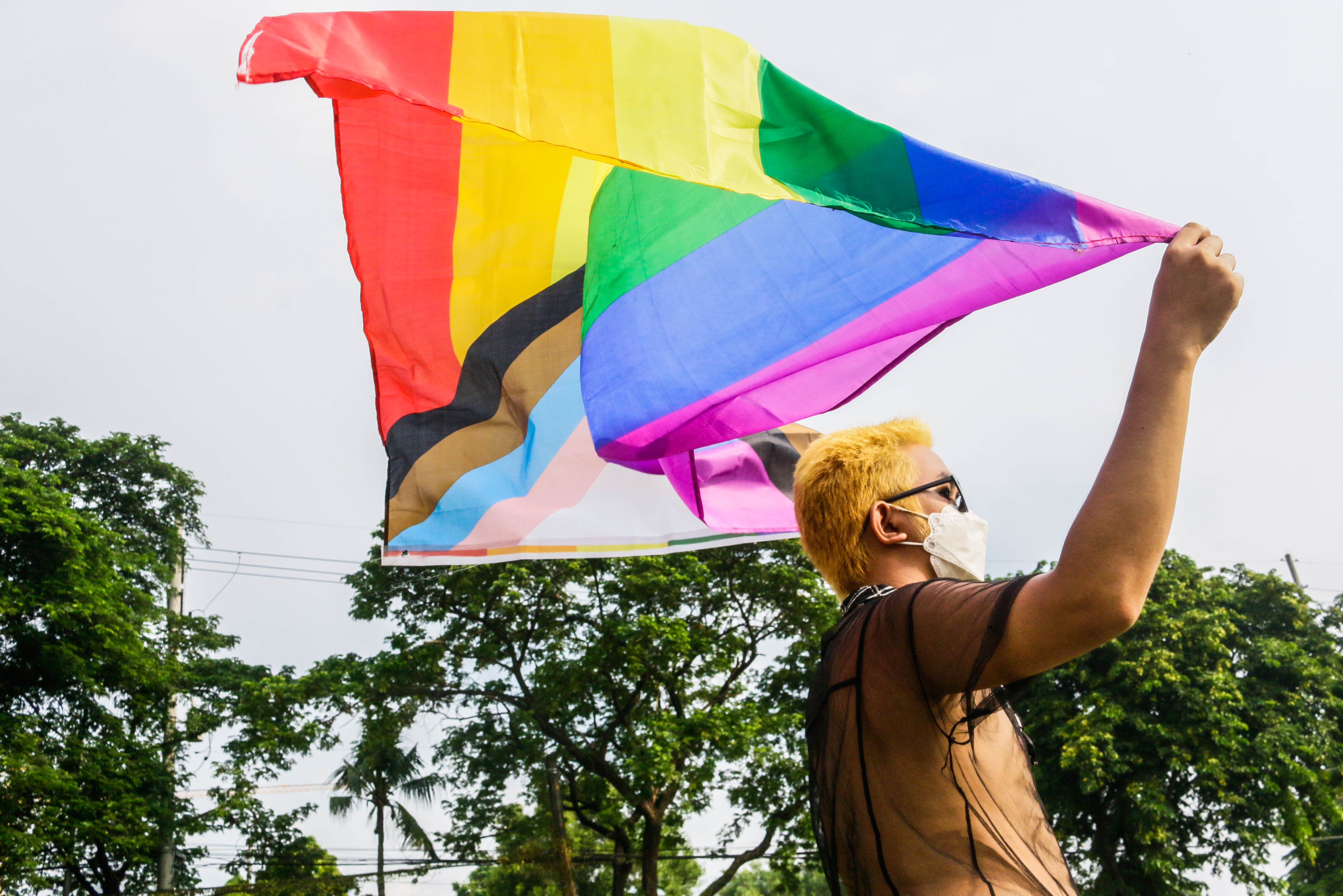A member of the LGBT community holds a pride flag during the